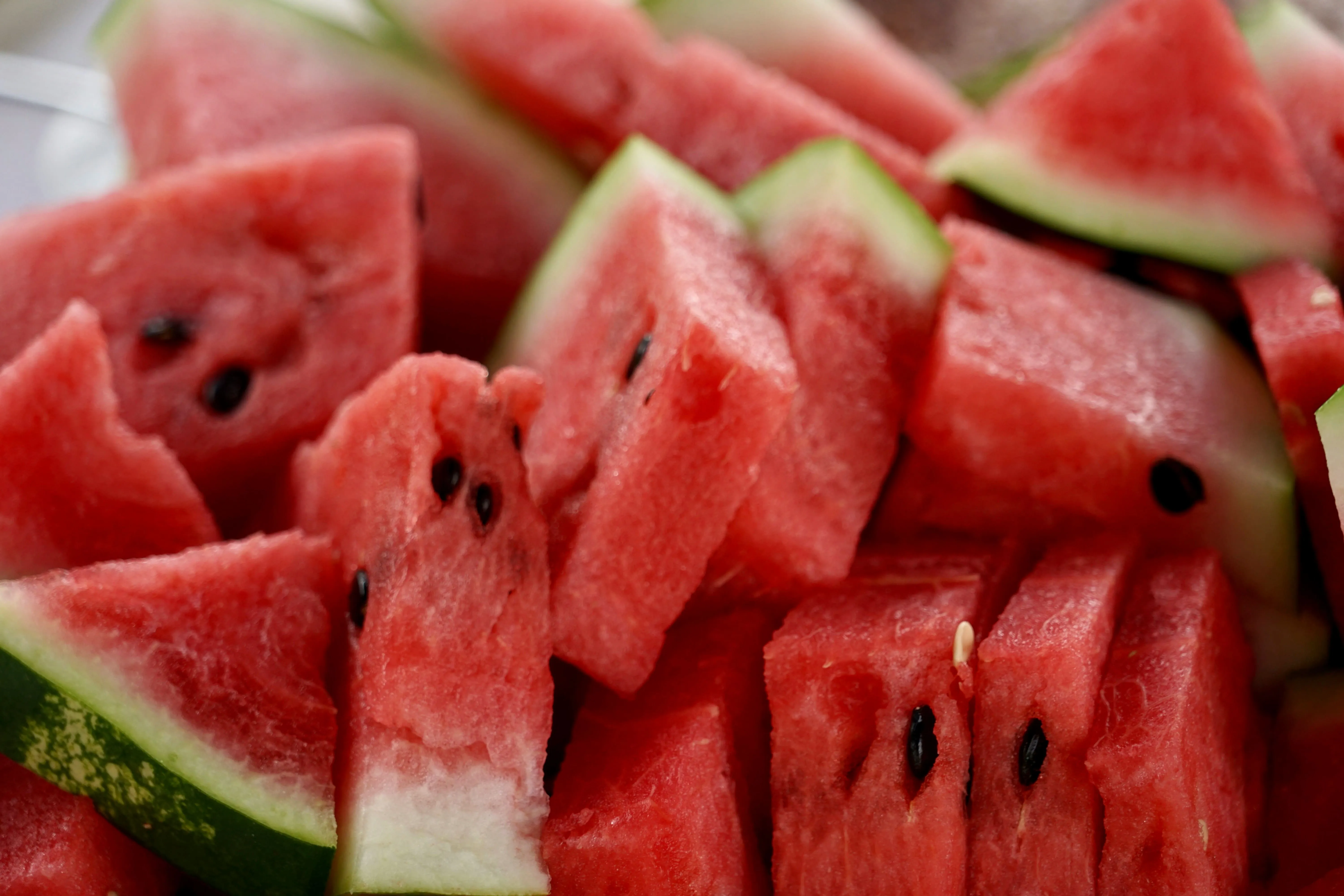 Sliced watermelon on a wooden surface, representing natural sources of L-citrulline for gut and skin health